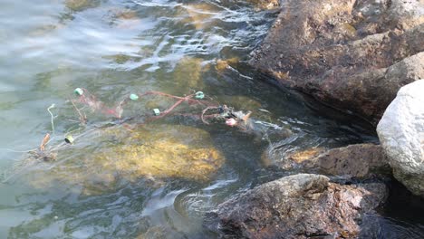 water flows over rocks, creating ripples and splashes.