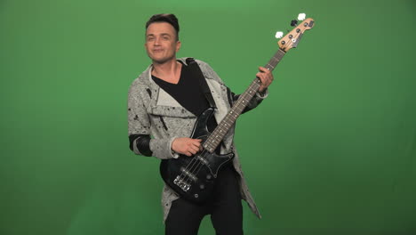 man playing bass guitar on green screen