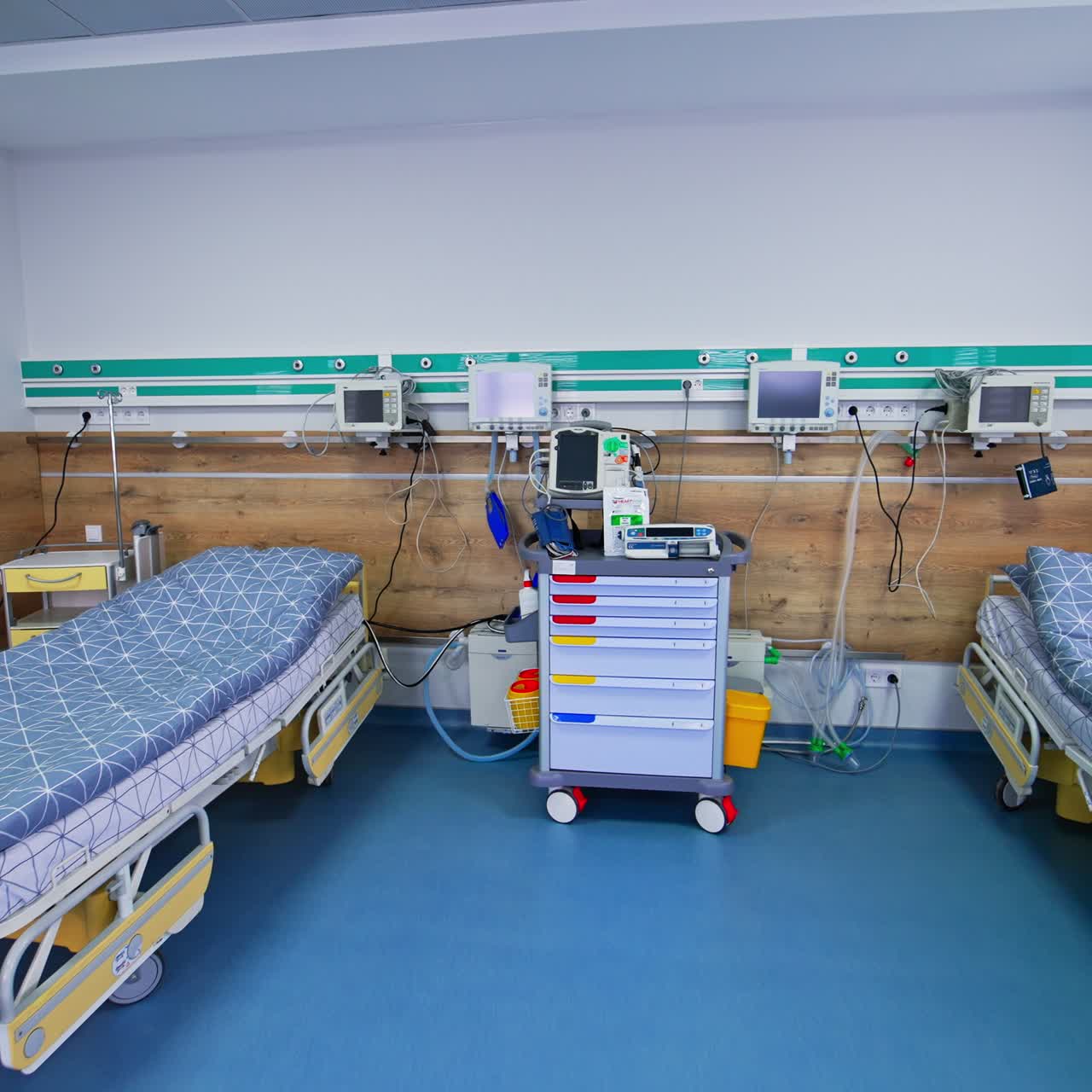 Diverse innovative equipment with screens and monitors in the resuscitation ward. Modern chamber with two beds for intensive care patients