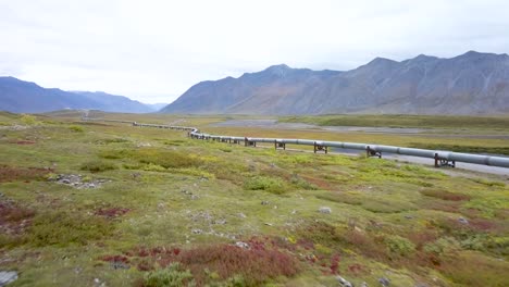 alaska landscape with oil pipeline running through the countryside - aerial