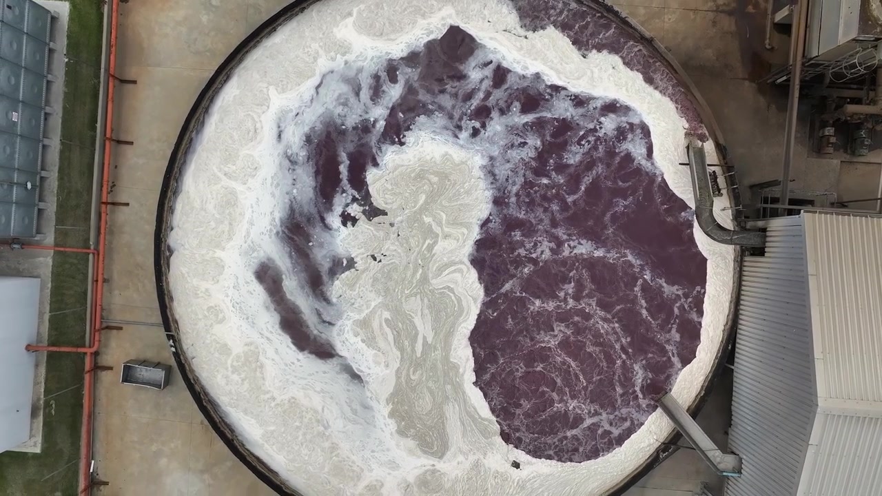 Aerial rotates above clarifier tank with bio foam and sludge water