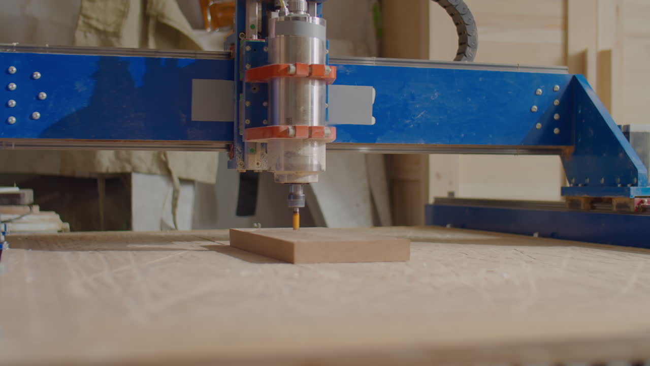 Woodworker Looking at Working CNC Machine