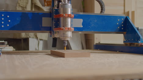 woodworker looking at working cnc machine