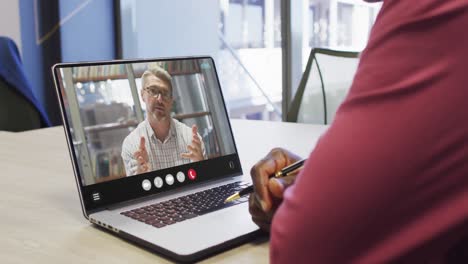 Animation-of-african-american-man-having-video-call-on-laptop