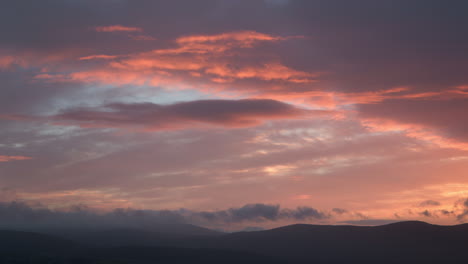 Blue-And-Pink-Sunrise,-Sunset-Clouds,-with-Mountains