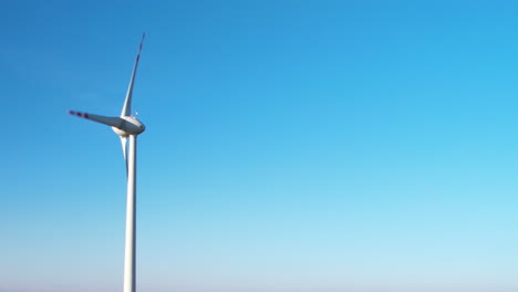 One-White-and-red-wind-turbine-against-a-blue-sky-with-copy-space