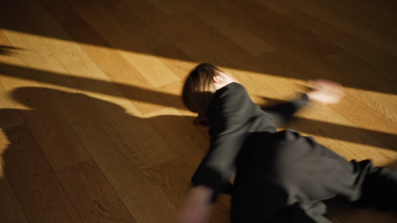 Person lying on wood floor