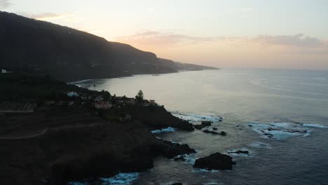 Aerial-capture-of-Punta-del-Guindastes-while-flying-over-it-during-the-sunset,-Tenerife