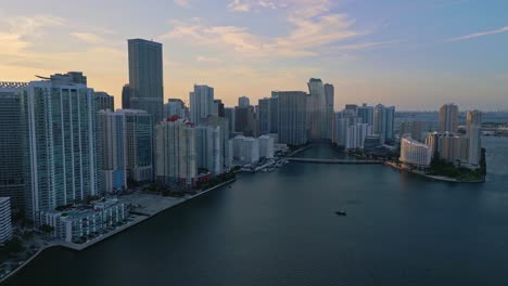 aerial backward shot of brickell bay at sunset, miami, florida, usa