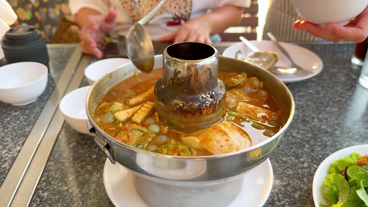 Sharing a meal of sour soup together