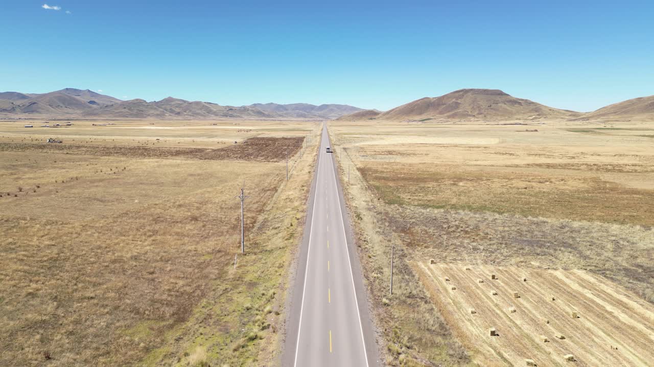 Car driving on Pan American Highway through mountain valley countryside in Peru