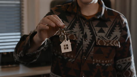 man showing key of new house