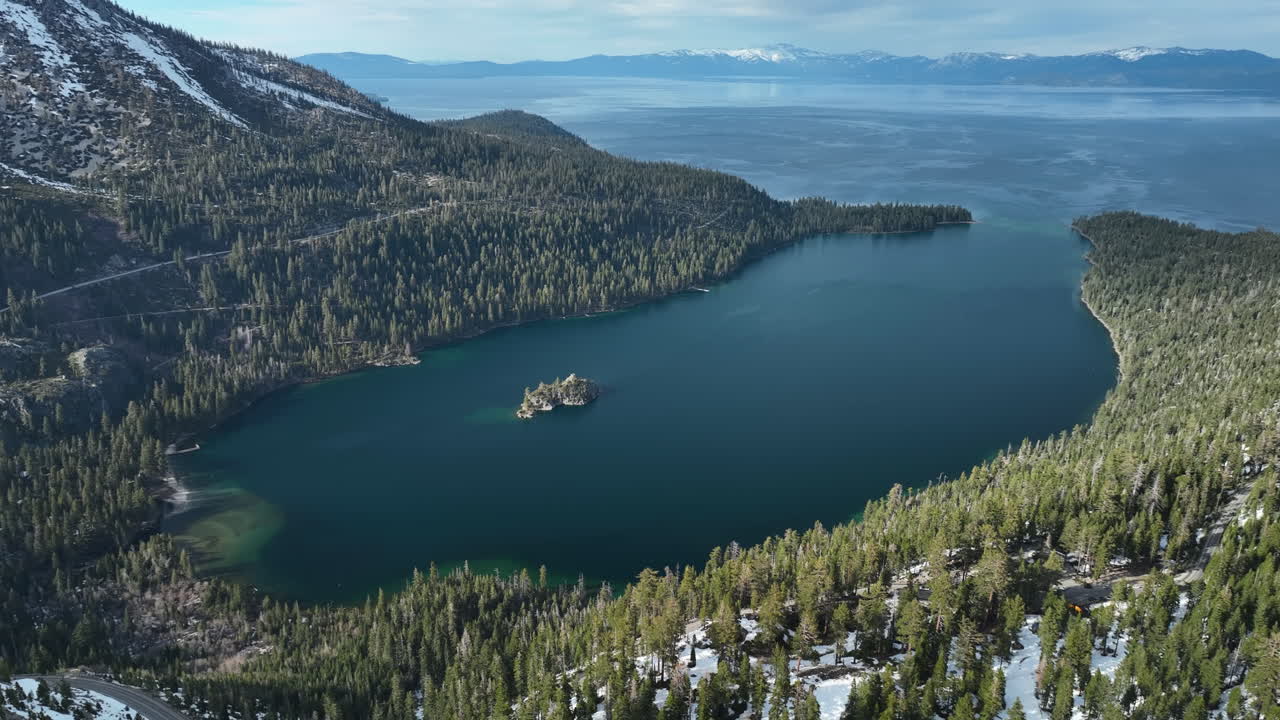 Panoramic drone shot around the wintry Emerald bay, spring day at Lake Tahoe, USA