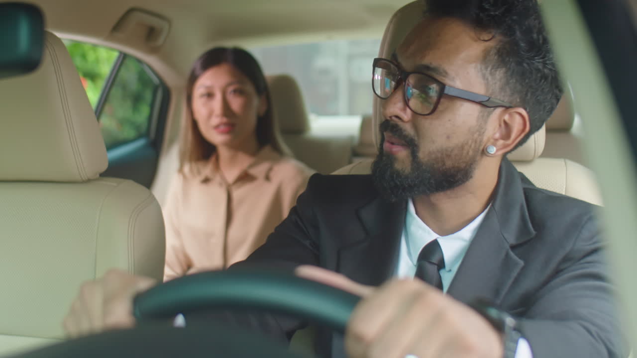 Taxi Driver Speaking with Businesswoman in Car