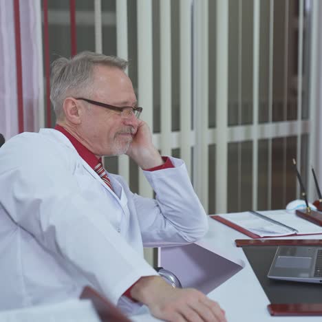 overworked doctor sitting in his office