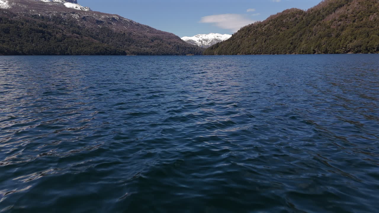 Panoramic drone view flying over water of Falkner Lake in Nahuel Napi National Park. Argentina. 4k.