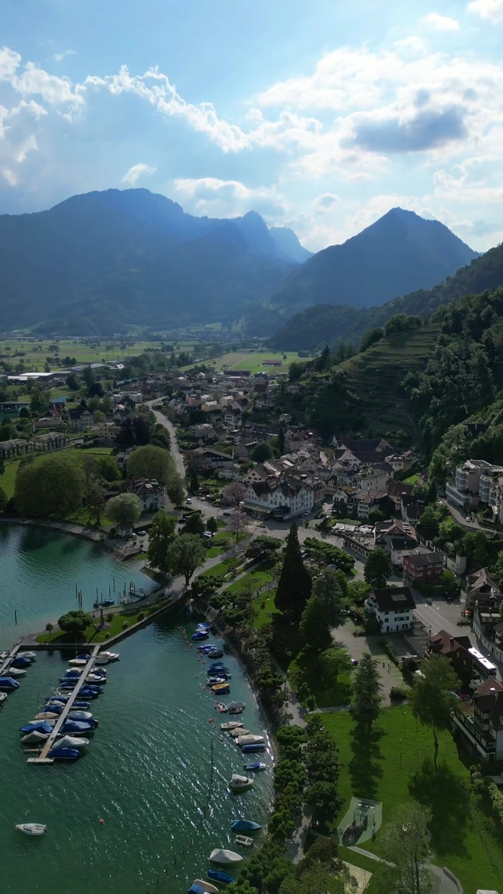 Weesen village on the shores of Lake Walen Walensee in Switzerland aerial drone vertical video