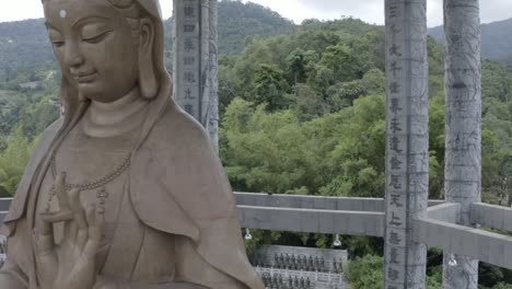 Close-up-tracking-shot-Kuan-Yin-statue,-Kek-Lok-Si-Temple,-Malaysia,-Penang-Hill,-no-people,-daylight,-beautiful-drone-flight