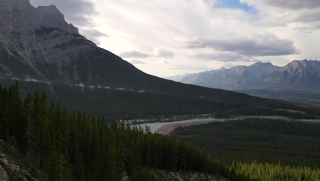 Slow-aerial-push-in-movement-above-the-Canadian-Rocky-mountains-covered-by-vast-forests