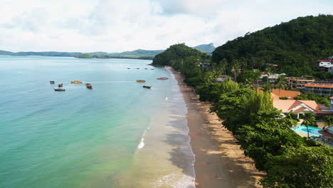 Ao-Nang-coastline-in-Thailand-with-boats-in-the-water,-aerial-view