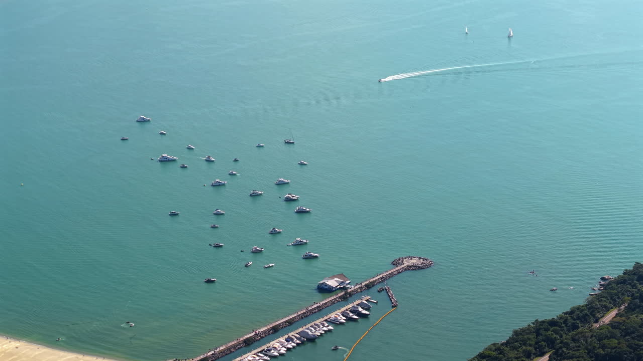 Drone view of Balneário Camboriú marina with anchored boats and yachts on turquoise ocean waters