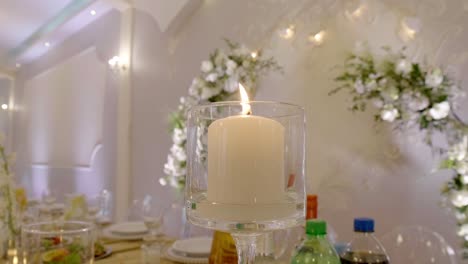 decorative candle lit on a wedding table