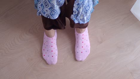 close up of a woman wearing pink polka dot ankle socks