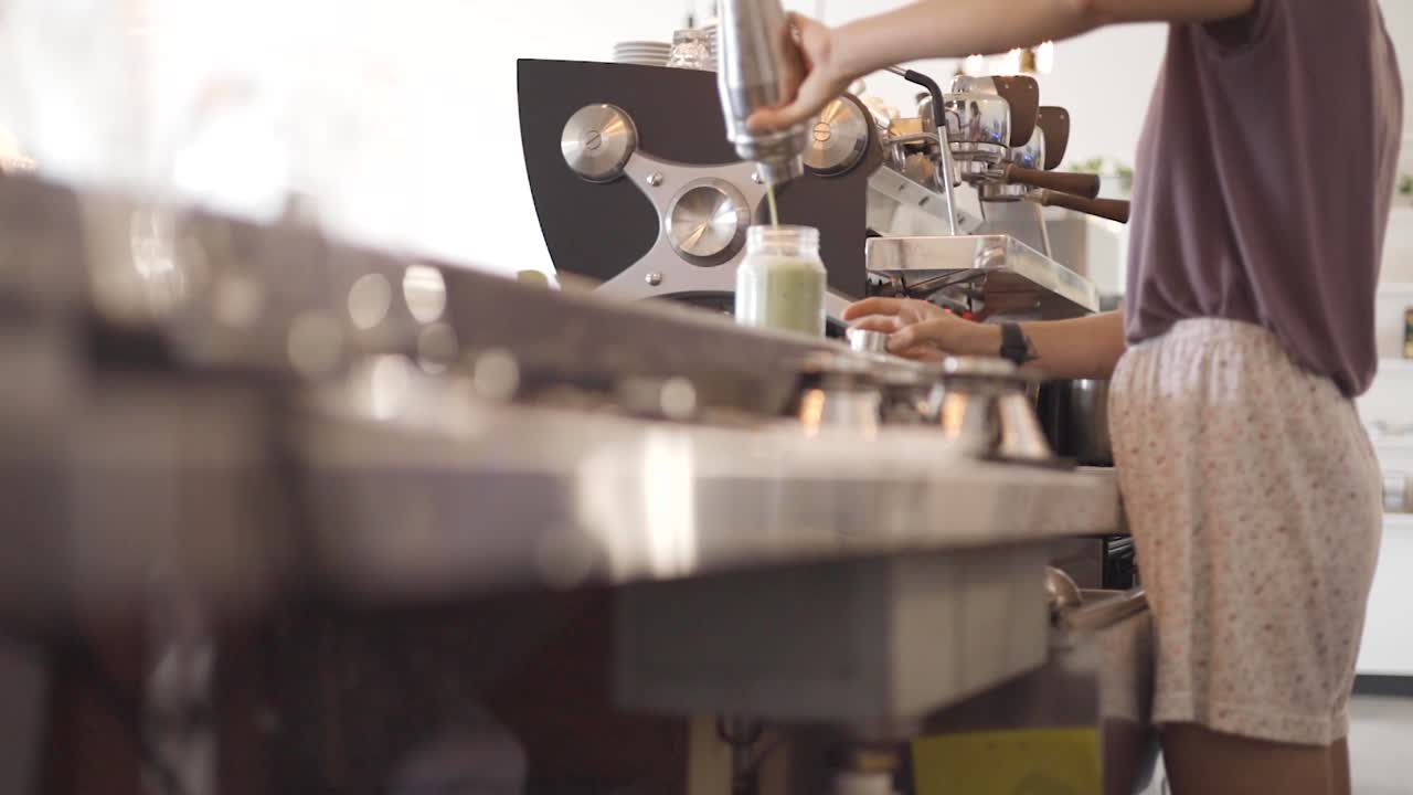 Woman making cup of coffee at coffee shop-1