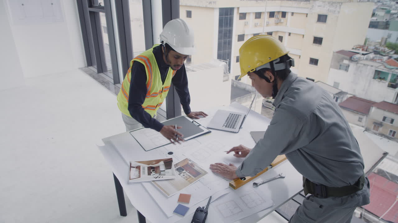 Diverse Architects Editing Blueprint at Desk