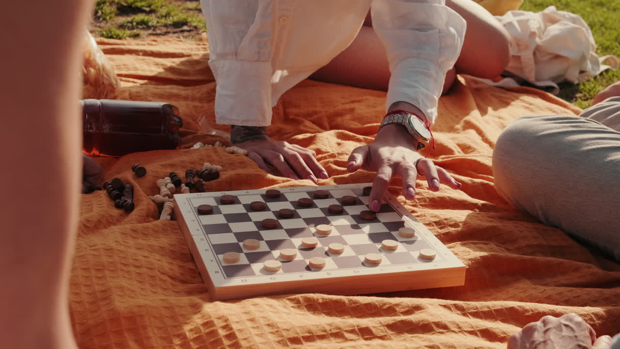 Friends Playing Checkers at a Picnic