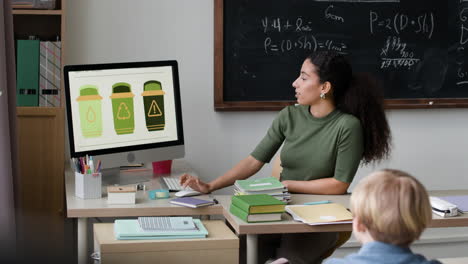 Teacher explaining different types of waste in a classroom