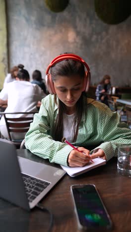 young woman studying in a cafe