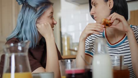 handheld video of women talking to each other during breakfast.