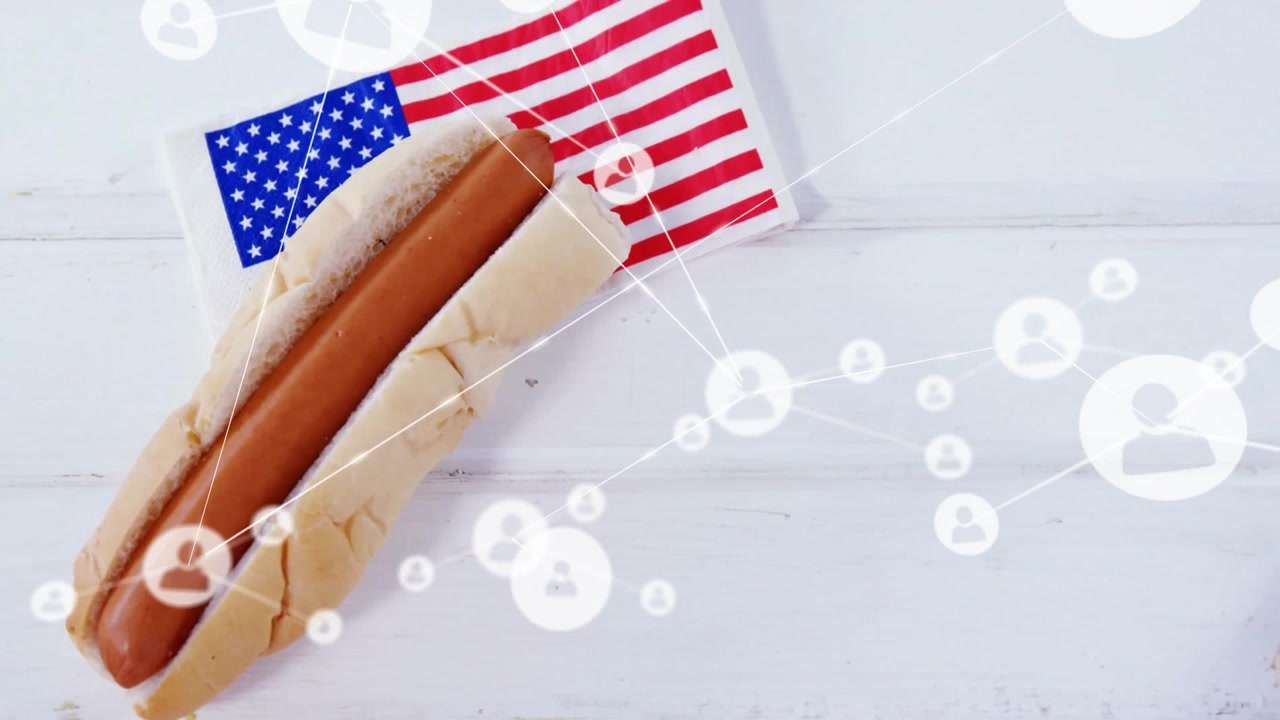 Frame changing spawning icon network forming obscuring hot dog with small flag lying on white plank