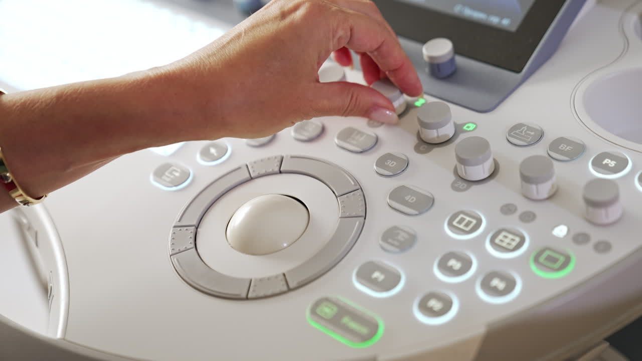 Hand Operating Ultrasound Machine Controls