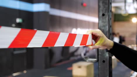 red and white striped barrier tape roll put on poals indoor