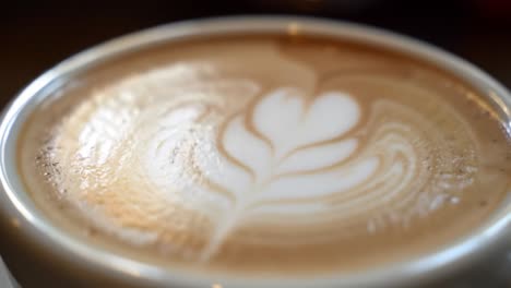 captivating close-up of creamy coffee with delicate latte art showcasing expert barista skills and a rich, velvety texture ideal for coffee lovers