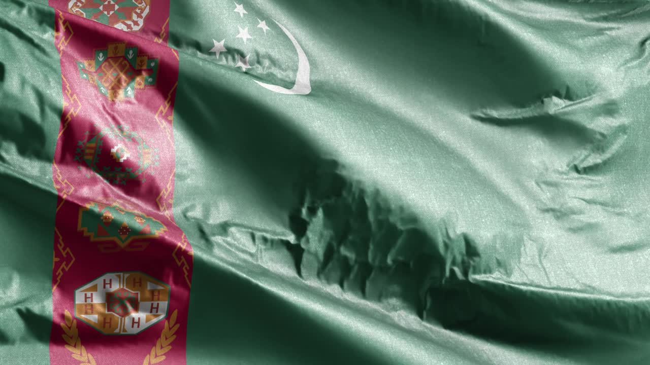 bandera textil de turcomanistán ondeando en el bucle del viento. bandera turcomana balanceándose en la brisa. tejido textil de tela. fondo de relleno completo. bucle de 10 segundos.