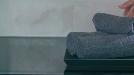 view of woman hand putting on plate rolls of towels