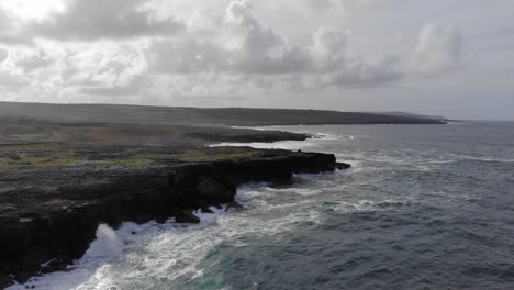aerial: rising drone with panoramic view of rugged irish coastline