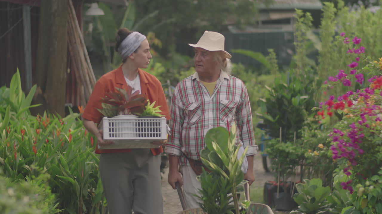 Plant Nursery Coworkers Walking in Garden and Talking