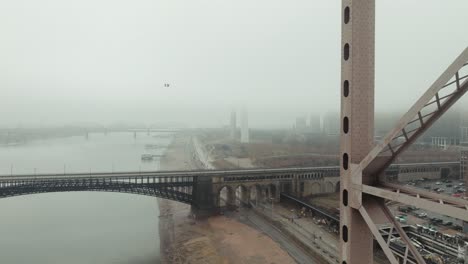 flying through truss of martin luther king bridge, view of foggy of st