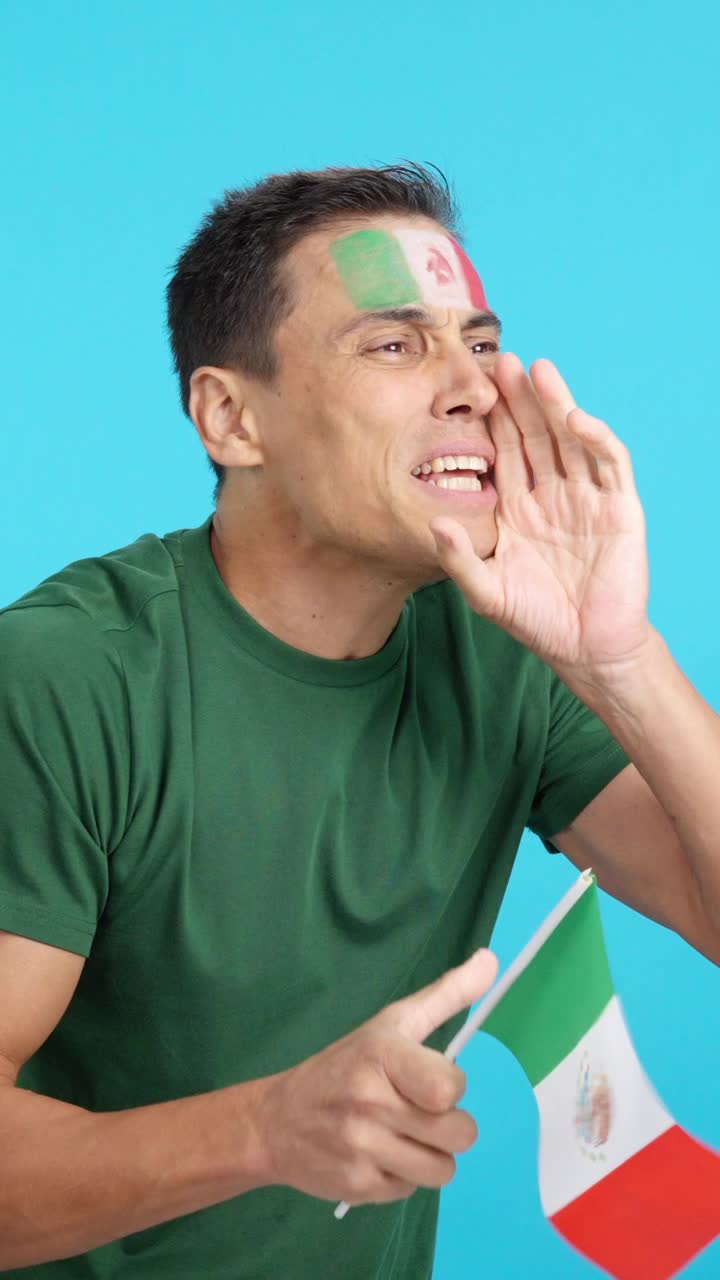Nervous man cheering for Mexico during a match looking away
