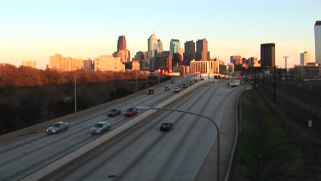 chicago glows during the goldenhour as traffic enters and departs the city via a divided expressway