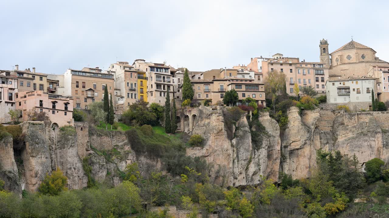 An overcast winter sky hangs above the famous Hanging Houses (Casas Colgadas) of Cuenca, Spain, creating a dramatic and moody scene of this historic city.