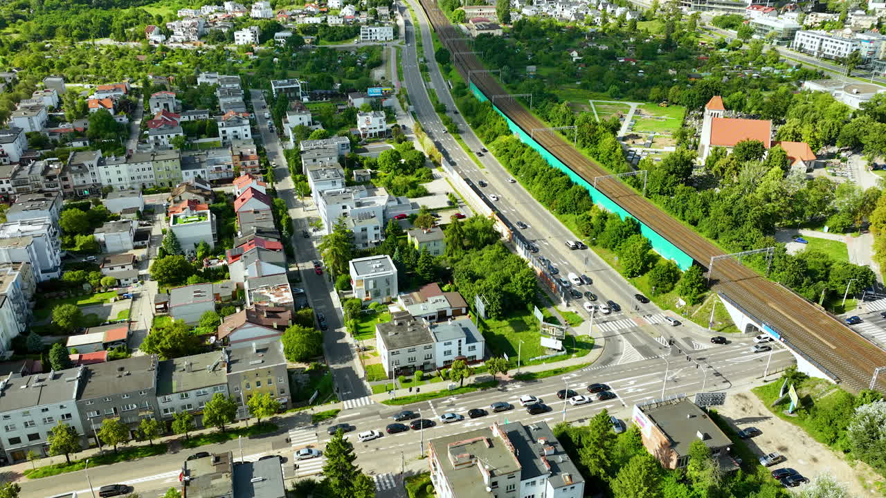 Aerial View of a City with Residential Buildings, Roads, and Railway Tracks