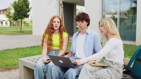 students collaborating on laptop