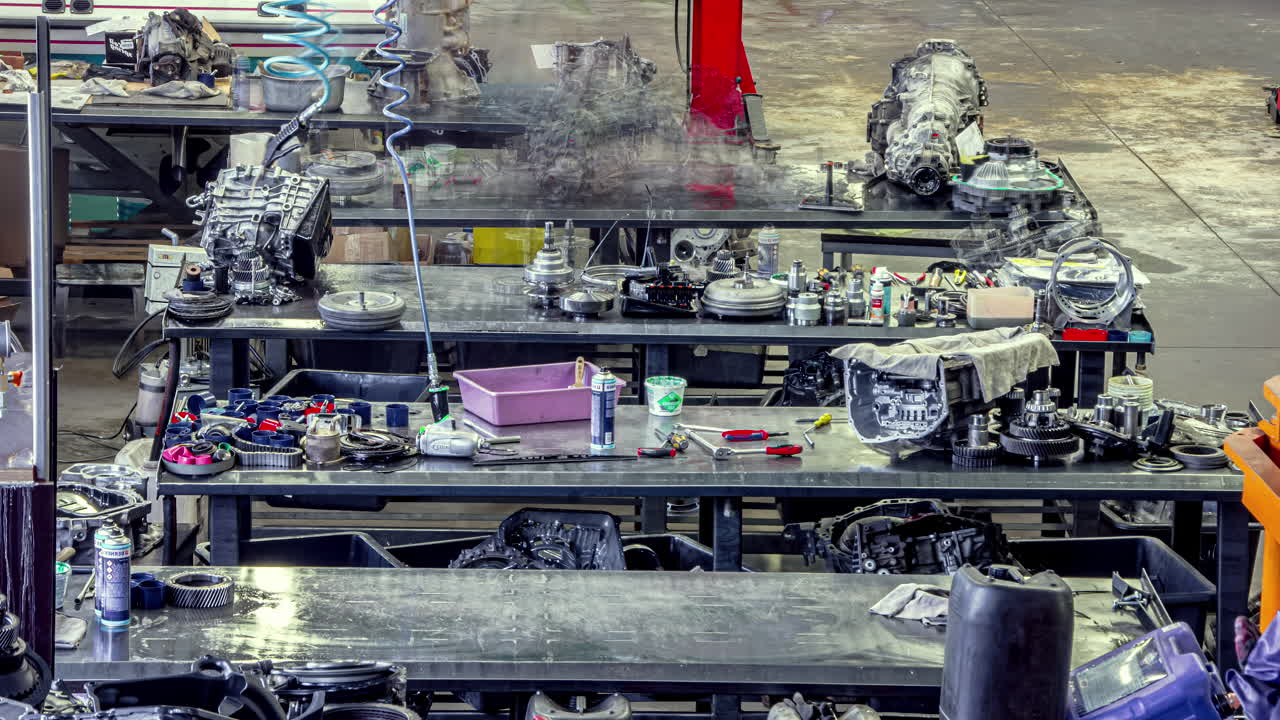 Mechanic's garage with automobile engines being repaired and rebuilt - time lapse