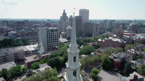 Aerial-orbit-of-the-spire-of-First-Unitarian-Church-with-the-skyline-of-Providence-RI-in-the-background