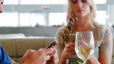 young couple using mobile phone